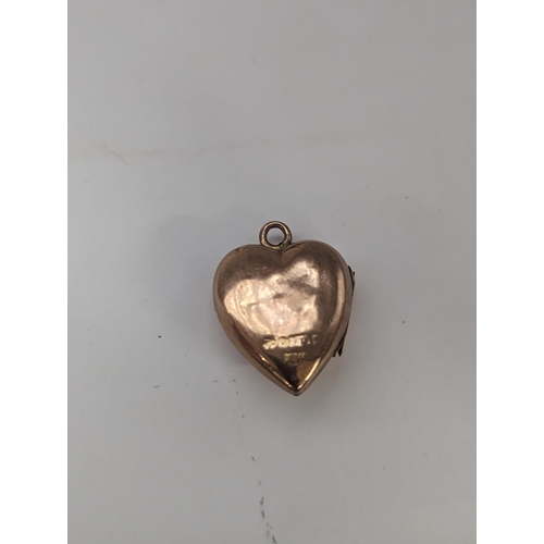 121 - A 9ct gold heart shaped locket pendant inset with central seed pearl, 2.5g
Location: CAB3