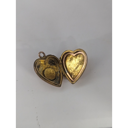 121 - A 9ct gold heart shaped locket pendant inset with central seed pearl, 2.5g
Location: CAB3