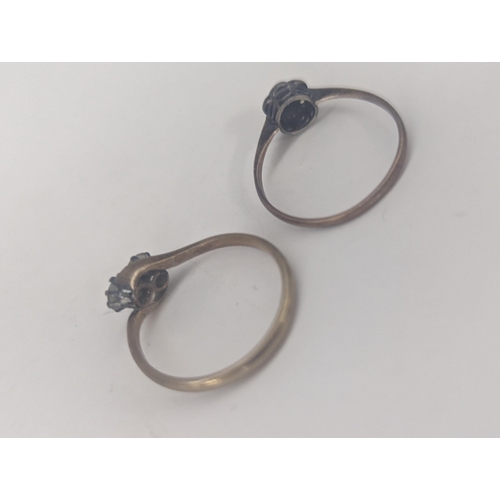 122 - Two 9ct rings to include a twisted style example set with a pair of white sapphires together with a ... 