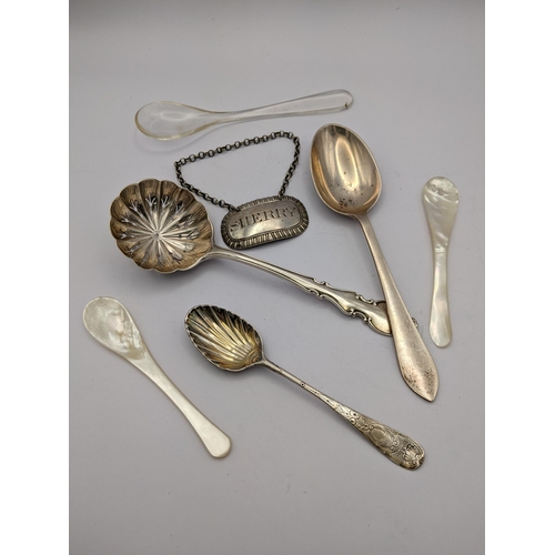 272 - A group of mixed silver items to include a silver sugar sifter soon, a shell caddy spoon, one other ... 