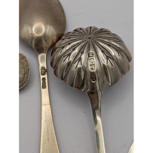 272 - A group of mixed silver items to include a silver sugar sifter soon, a shell caddy spoon, one other ... 