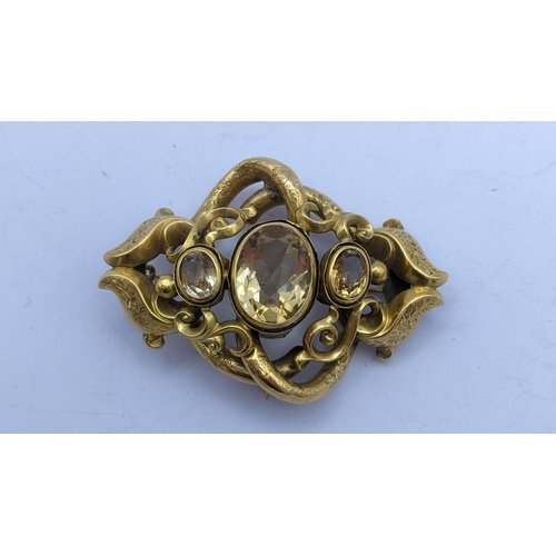 276 - A Victorian pinchbeck brooch having three faceted cut Citrines in a scrolled frame
Location: CAB5