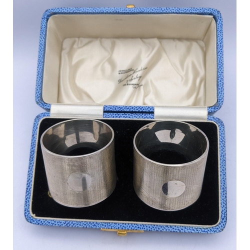 282 - A pair of boxed 1930's silver engine turned napkin rings by Davidson Henderson & Sorley, hallmarked ... 