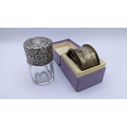 283 - An Edwardian silver topped scent bottle together with a silver pierced napkin ring
Location: BWR