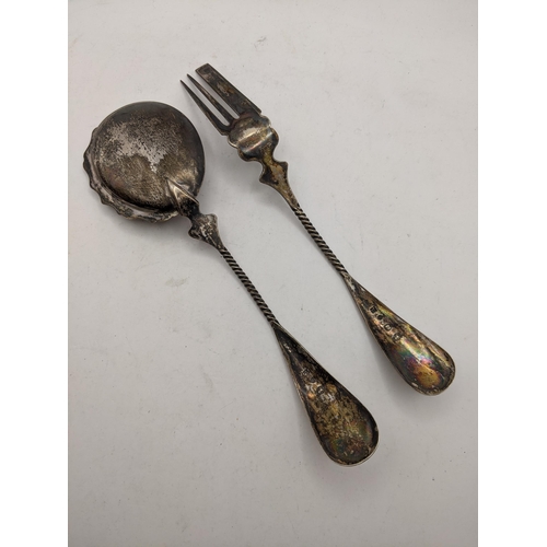 54 - A silver fork and serving spoon, possibly Dutch, both with ornately decorated handles and rope twist... 