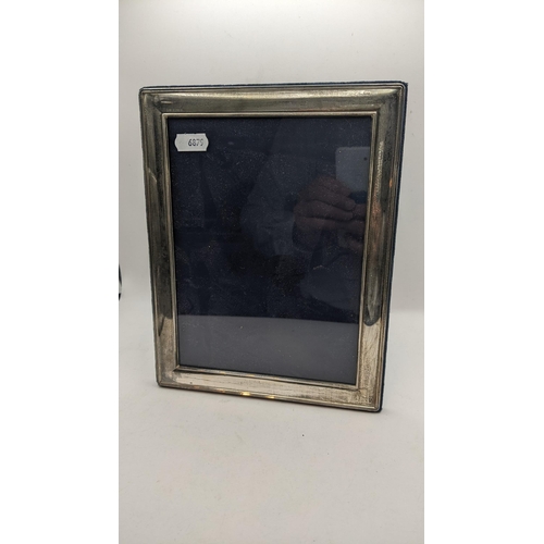 56 - Three large silver photograph frames to include one having a reeded border and easel backs
Location:... 