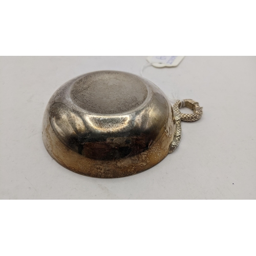 61 - A late 20th century silver tastevin with snake form ring handle, hallmarked Birmingham 1978, 73.5g
L... 