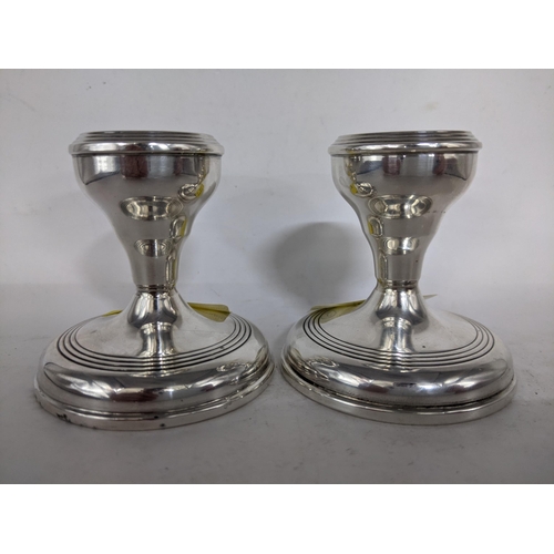 74 - A pair of silver swarf candlesticks with a ribbed rim and a ribbed circular base, Birmingham 1989
Lo... 