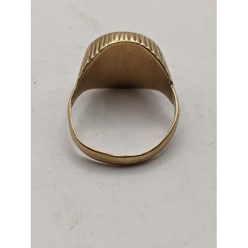 8 - A 9ct gold signet ring set with an Austrian coin, 5.6g Location: CAB1