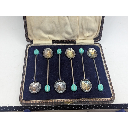 80 - A cased set of six early 20th century silver coffee bean spoons, 34.9g, together with silver handled... 