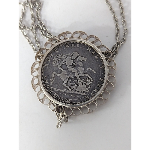 81 - A George III 1820 garter silver crown, in a white metal pendant on a chain
Location: CAB3