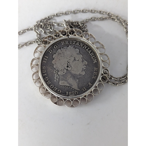 81 - A George III 1820 garter silver crown, in a white metal pendant on a chain
Location: CAB3