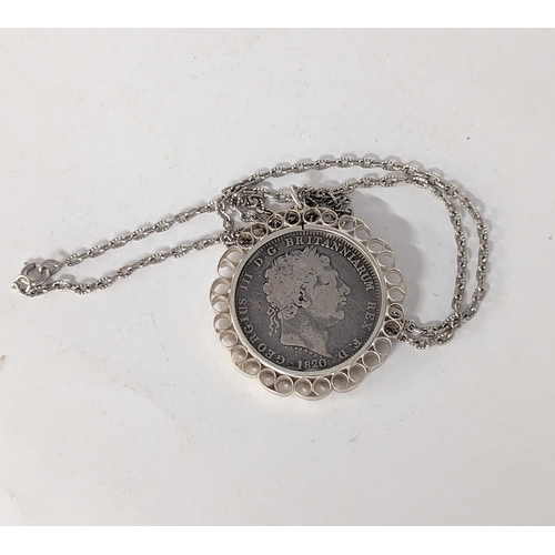 81 - A George III 1820 garter silver crown, in a white metal pendant on a chain
Location: CAB3