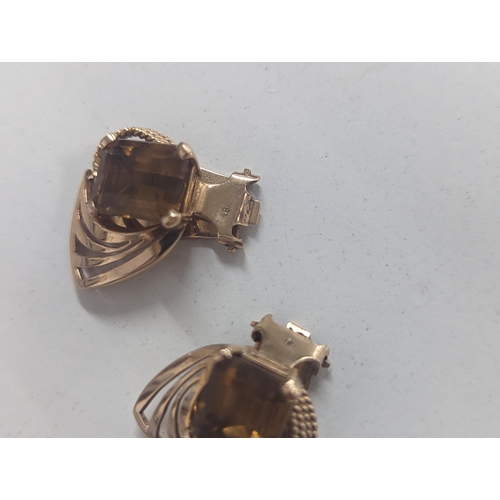 83 - A pair of stamped 18 gold, Art Deco inspired earrings inset with central citrinin, 11.1g, total weig... 