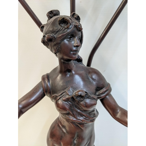 168 - A reproduction of a bronzed finished Art Nouveau style table lamp, fashioned as a woman with three g... 