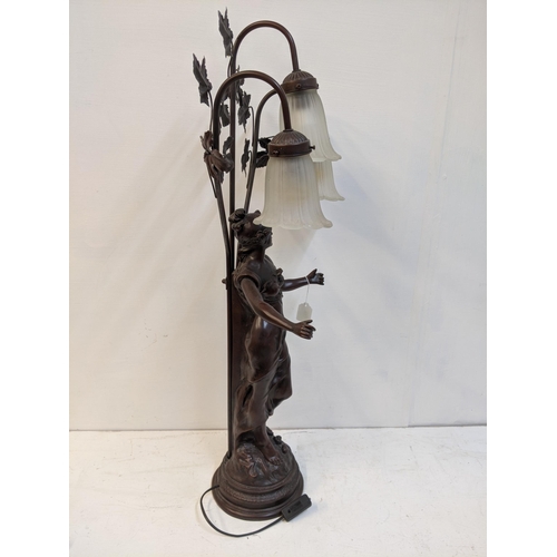 168 - A reproduction of a bronzed finished Art Nouveau style table lamp, fashioned as a woman with three g... 