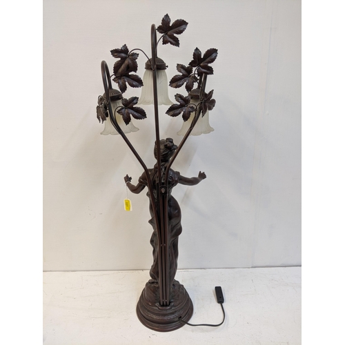 168 - A reproduction of a bronzed finished Art Nouveau style table lamp, fashioned as a woman with three g... 