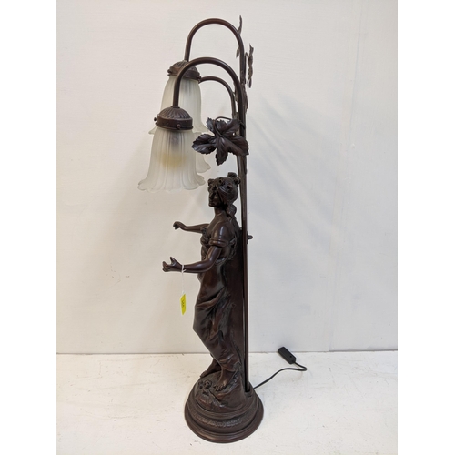 168 - A reproduction of a bronzed finished Art Nouveau style table lamp, fashioned as a woman with three g... 