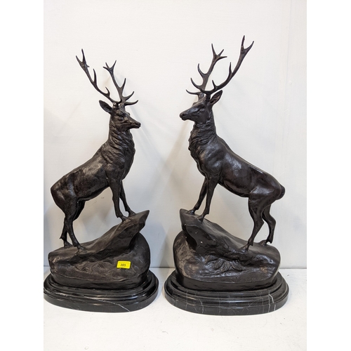 192 - After Jules Moizniez - a pair of late 20th century patinated bronze models of stags  on marble plint... 