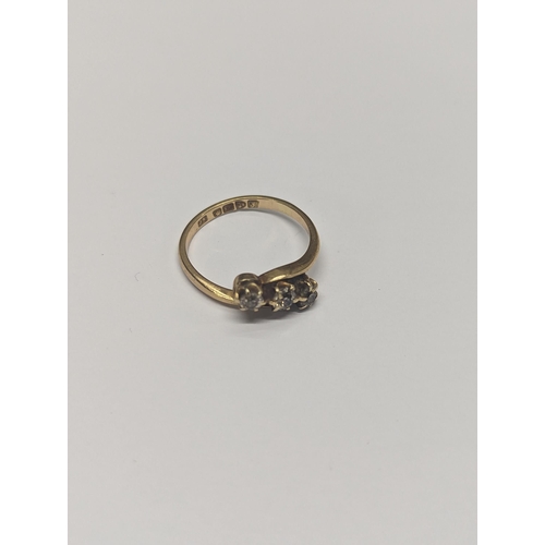 173 - An 18ct gold twist ring, inset with three diamonds, size N½,2.9
Location: CAB3