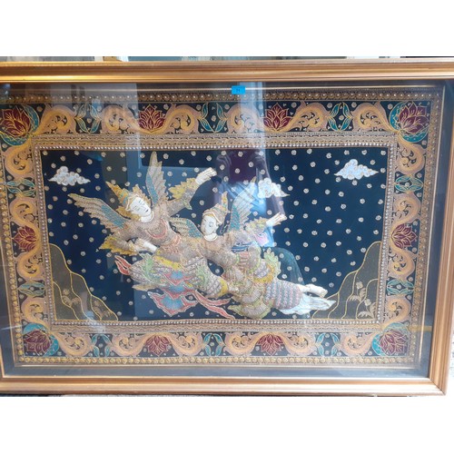 141 - A mid to late 20th Century large Thai embroidered picture depicting 2 goddesses flying with wings ag... 