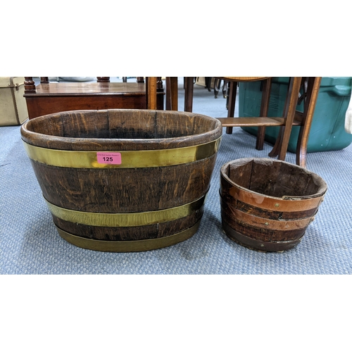 125 - Two 19th century oak brass and copper bound buckets to include an oval framed example 24.5h x 41w cm... 