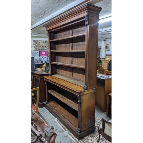 14 - A Victorian walnut bookcase having a stepped cornice open shelves and a plinth base 147h x 181.5w
Lo... 