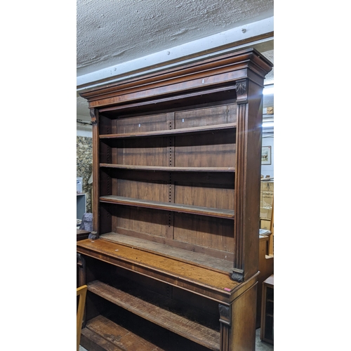 14 - A Victorian walnut bookcase having a stepped cornice open shelves and a plinth base 147h x 181.5w
Lo... 