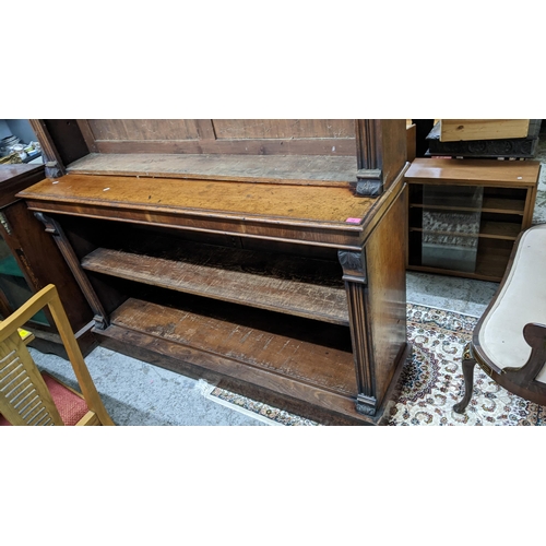 14 - A Victorian walnut bookcase having a stepped cornice open shelves and a plinth base 147h x 181.5w
Lo... 