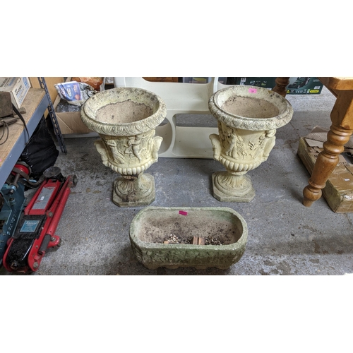 153 - A pair of lightly weathered garden pedestal urns, classical figurative decoration cast in relief wit... 