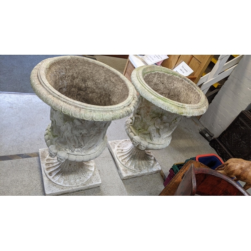 154 - A pair of large garden urn planters in the Neo Classical design having egg and dart border above mou... 