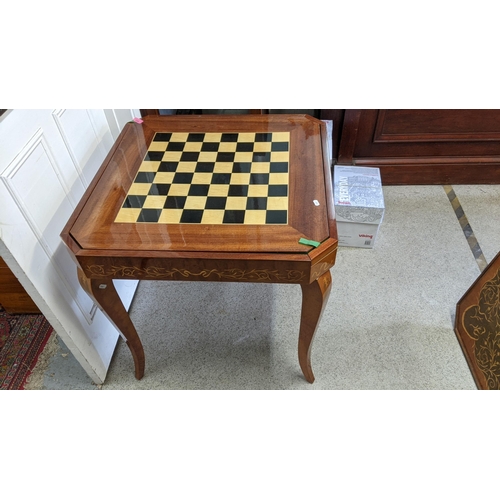 159 - A Sorrento parquetry inlaid games table having removeable top with changeable game tops 75cm h x 77c... 