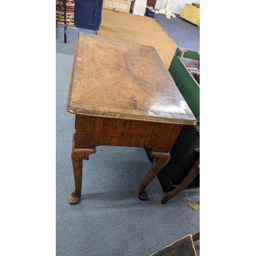 17 - An early  18th century quarter cut veneered walnut lowboy having three drawers and a carved apron 70... 