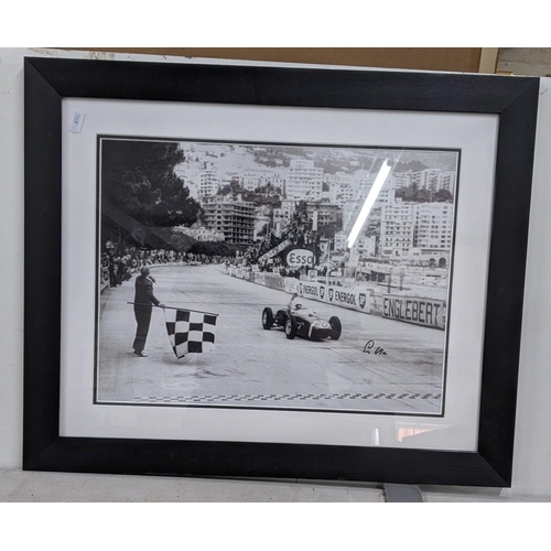 18 - A black and white reprinted photograph of Stirling Moss in a car, signed
Location:RWM