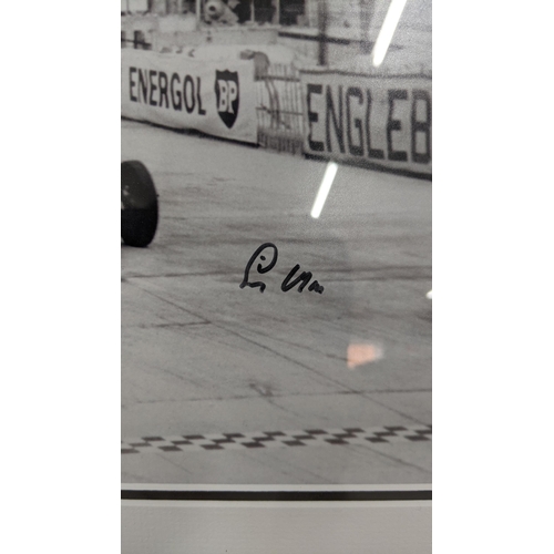 18 - A black and white reprinted photograph of Stirling Moss in a car, signed
Location:RWM