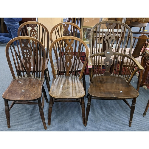 182 - A late 19th/early 20th century elm and ash Windsor spindle back armchair and a set of four dining ch... 