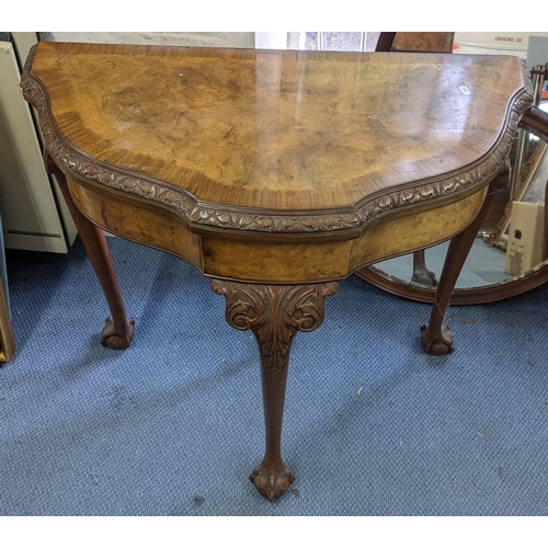 183 - An early 20th century walnut fold over card table having cabriole legs with ball and claw feet, 77cm... 