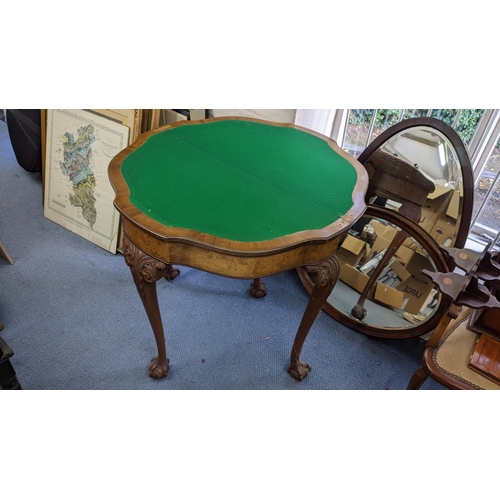 183 - An early 20th century walnut fold over card table having cabriole legs with ball and claw feet, 77cm... 