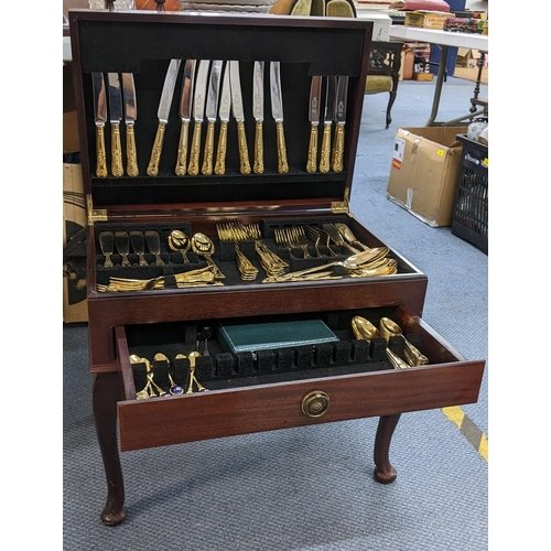 20 - A late 20th century mahogany cutlery table containing mixed Kings pattern gilded cutlery
Location:A1... 