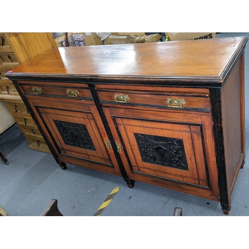 208 - A Victorian walnut sideboard having two drawers above two carved panelled doors Location:RAM