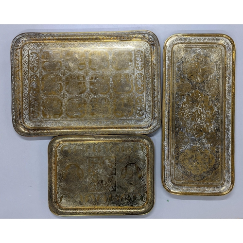 221 - Three Middle Eastern brass trays to include one depicting scenes of warriors Location:BWR