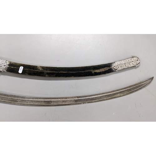 222 - A late 19th/early 20th century Shaska sabre presentation style with a white metal mounted scabbard, ... 