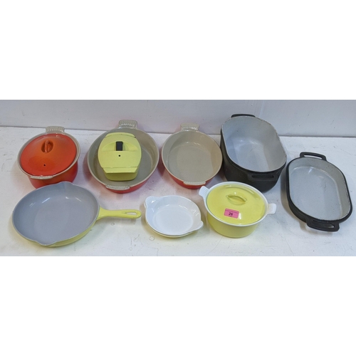 26 - A collection of enamel kitchenware to include some Le Creuset enamel severing and casserole dishes a... 