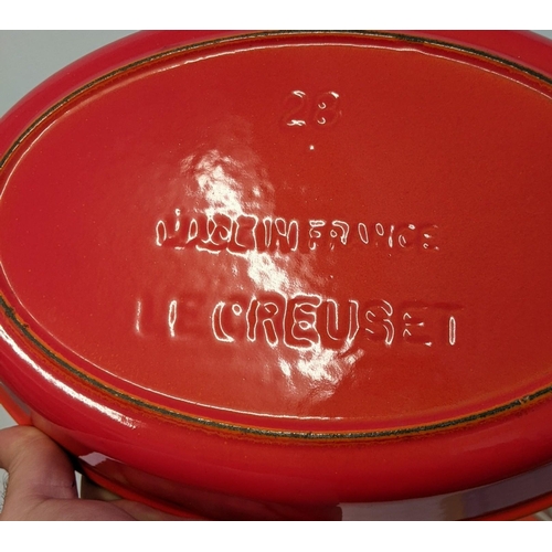 26 - A collection of enamel kitchenware to include some Le Creuset enamel severing and casserole dishes a... 