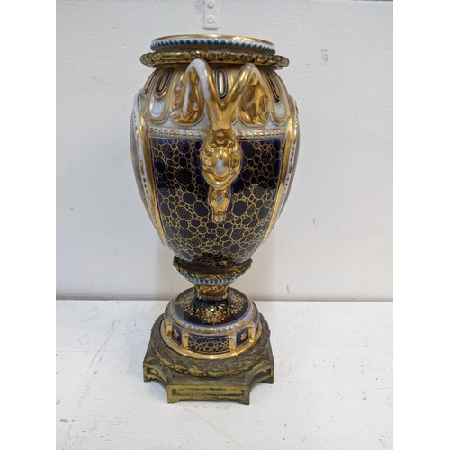 273 - A 19th century porcelain and gilt metal vase and cover decorated with panels of flowers and figures ... 