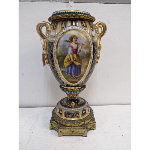 273 - A 19th century porcelain and gilt metal vase and cover decorated with panels of flowers and figures ... 