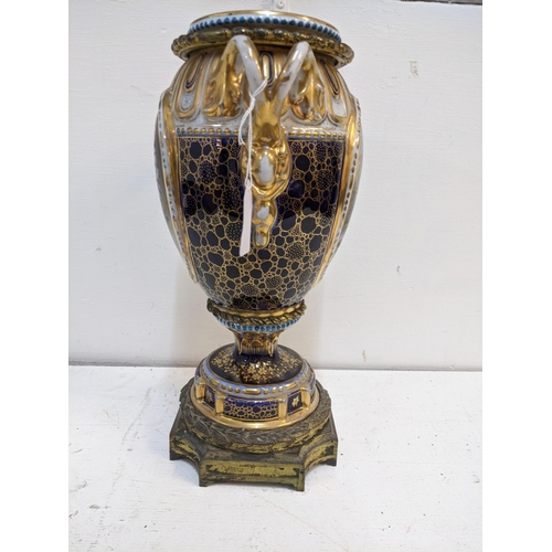 273 - A 19th century porcelain and gilt metal vase and cover decorated with panels of flowers and figures ... 