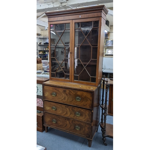 52 - A 19th century mahogany secretaire bookcase having astragal glazed doors above three drawers, 210cm ... 