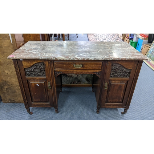 58 - A late Victorian walnut marble topped desk having a single drawer flanked by two carved doors 74h x1... 