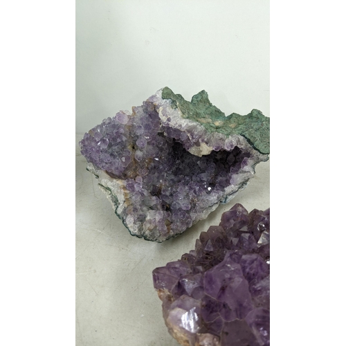 72 - Three large purple amethyst clusters, approx 12cm h x 18cm w, 9.5cm h x 18cm w, 7cm h x 17cm w toget... 